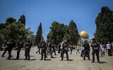 Israeli security forces guard as a group of religious Jews visit the Temple Mount, in Jerusalem's Old City, during Tisha B'Av, on July 18, 2021. (Jamal Awad/Flash90)