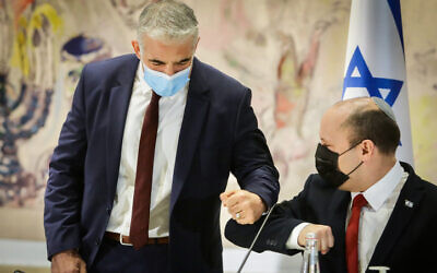 Foreign Minister Yair Lapid and Prime Minister Naftali Bennett at a cabinet meeting at the Knesset, on July 19, 2021.  (Marc Israel Sellem/Pool)