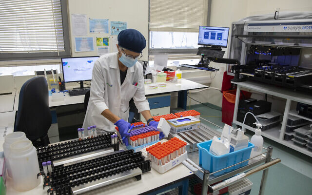 Medical staff analyze PCR COVID-19 tests at a Clalit Health Services laboratory in Jerusalem on July 22, 2021. (Olivier Fitoussi/Flash90) Medical staff analyze PCR COVID-19 tests at a Clalit Health Services laboratory in Jerusalem on July 22, 2021. (Olivier Fitoussi/Flash90)