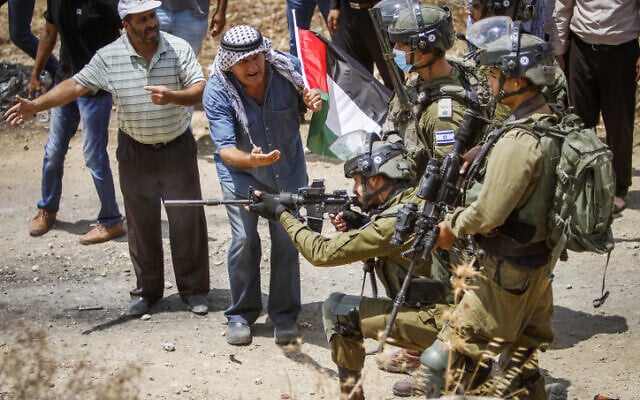 Palestinians clash with Israeli security forces during a protest in the northern West Bank on July 23, 2021. (Nasser Ishtayeh/Flash90) Palestinians clash with Israeli security forces during a protest in the northern West Bank on July 23, 2021. (Nasser Ishtayeh/Flash90)