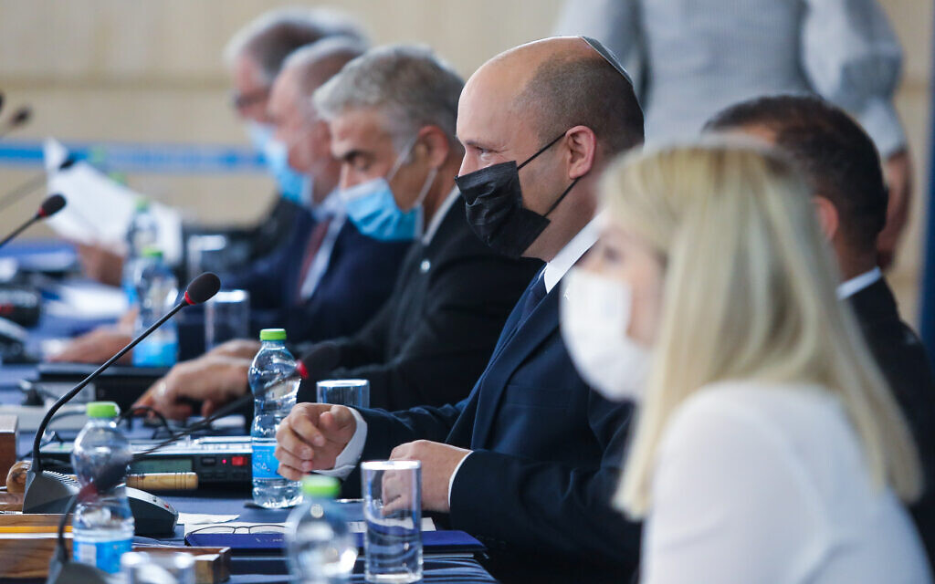 Prime Minister Naftali Bennett, center wearing black mask, during a cabinet meeting at the Foreign Ministry in Jerusalem on July 25, 2021. (Marc Israel Sellem/Pool) Prime Minister Naftali Bennett, center wearing black mask, during a cabinet meeting at the Foreign Ministry in Jerusalem on July 25, 2021. (Marc Israel Sellem/Pool)