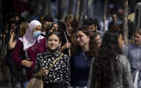 People, some wearing face masks, walk on Jaffa Street in Jerusalem, July 25, 2021. (Olivier Fitoussi/Flash90)