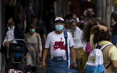 People, some wearing face masks, walk on Jaffa Street in Jerusalem, July 25, 2021. (Olivier Fitoussi/Flash90)