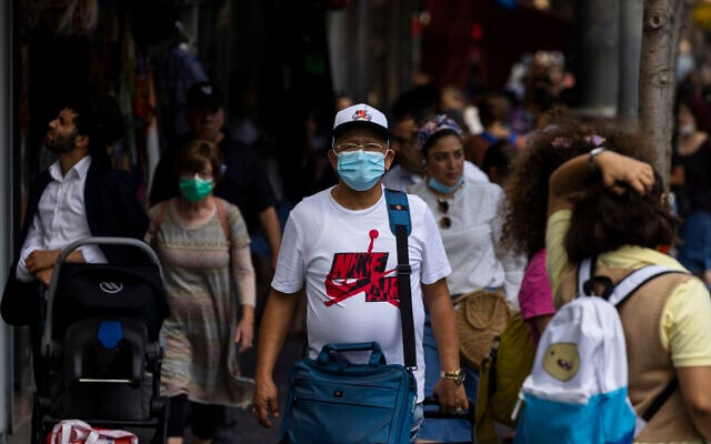 People, some wearing face masks, walk on Jaffa Street in Jerusalem, July 25, 2021. (Olivier Fitoussi/Flash90) People, some wearing face masks, walk on Jaffa Street in Jerusalem, July 25, 2021. (Olivier Fitoussi/Flash90)