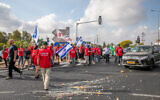 Farmers block the Bilu Junction as part of protests around the country against the finance and agriculture ministries plan to open up the fruit and vegetable market for import, on July 29, 2021. (Yossi Aloni/Flash90)