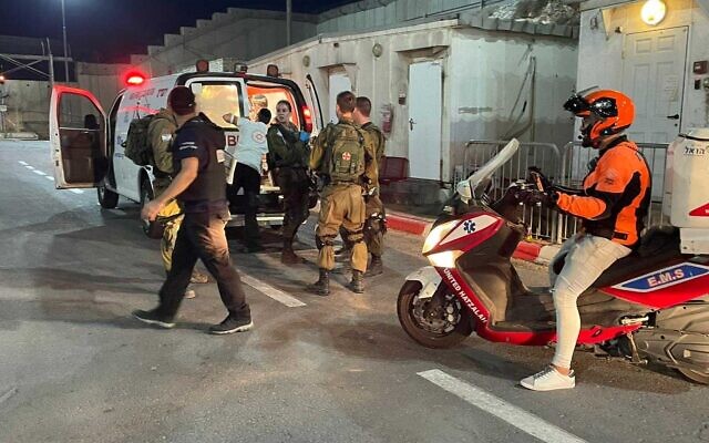 A guard is treated a the Qalandia checkpoint in the West Bank after being wounded in a drive by shooting (United Hatzalah) A guard is treated a the Qalandia checkpoint in the West Bank after being wounded in a drive by shooting (United Hatzalah)