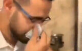 Mohamad Nader Badarneh is seen blowing his nose on a banknote in Turkey. (Screenshot: Twitter)