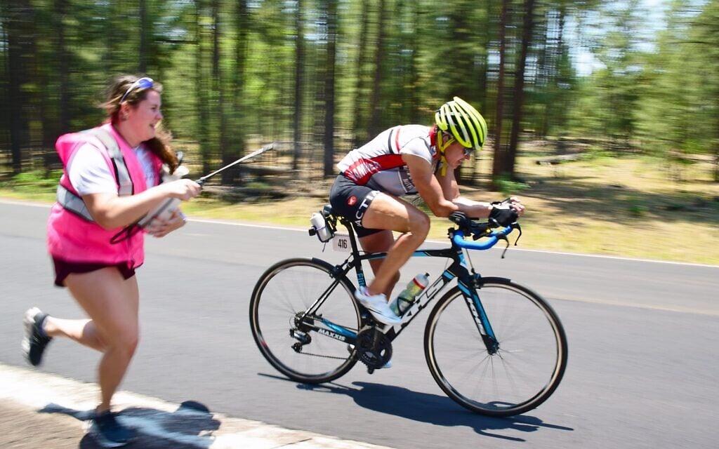 One of Leah Goldstein's crew cools her down as she pulls into 2nd place overall through Tuba City, Arizona in Race Across America 2021, June 18, 2021 (Vic Armijo/RAAM Media)