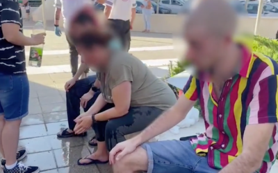 Three Ariel pride particapants are tended to after being doused with pepper spray on July 8, 2021. (Screen capture/YouTube)