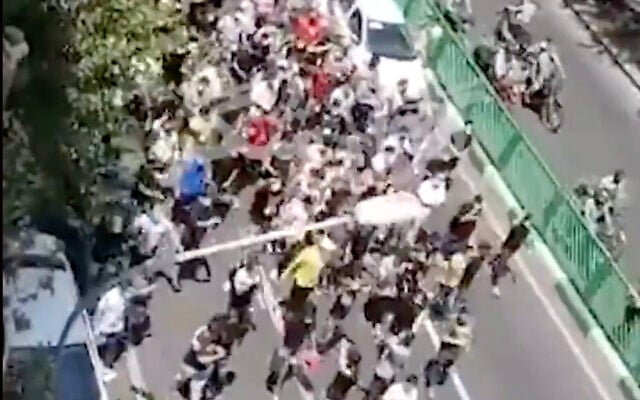 A screenshot from video of protesters marching in Tehran, Iran, on July 26, 2021. (Screen capture: Twitter) A screenshot from video of protesters marching in Tehran, Iran, on July 26, 2021. (Screen capture: Twitter)