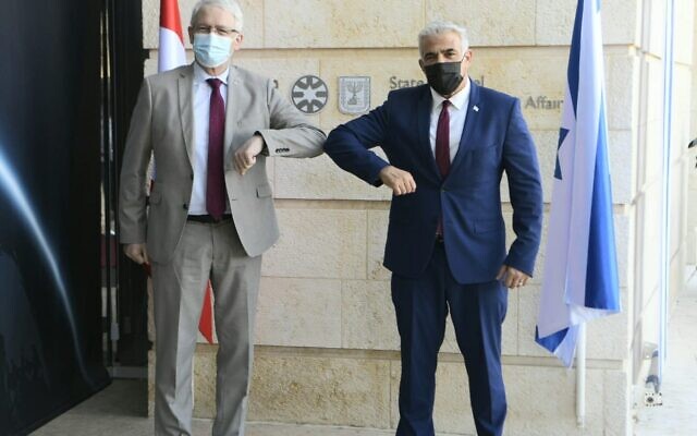 Foreign Minister Yair Lapid (right) and Canadian Foreign Minister Marc Garneau meet at the Foreign Ministry in Jerusalem on July 4, 2021. (Avi Ohayon/Foreign Ministry) Foreign Minister Yair Lapid (right) and Canadian Foreign Minister Marc Garneau meet at the Foreign Ministry in Jerusalem on July 4, 2021. (Avi Ohayon/Foreign Ministry)