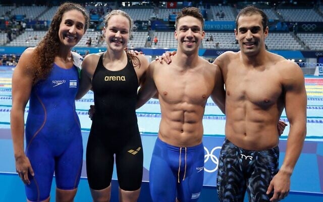 Israeli swimmers (from left) Andi Murez, Anastasia Gorbenko, Gal Cohen Groumi and Itay Goldfaden at the mixed 4x100 medley relay at the Tokyo 2020 Olympics on July 29, 2021. (Simona Castrovillari/Israel Olympic Committee) Israeli swimmers (from left) Andi Murez, Anastasia Gorbenko, Gal Cohen Groumi and Itay Goldfaden at the mixed 4x100 medley relay at the Tokyo 2020 Olympics on July 29, 2021. (Simona Castrovillari/Israel Olympic Committee)