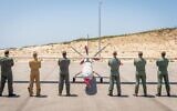 Drone pilots from five countries and Israel pose in front of a Hermes-450 unmanned aerial vehicle during an international exercise, dubbed Blue Guardian, which launched on July 12, 2021. (Israel Defense Forces)