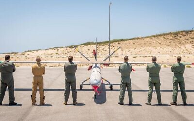 Drone pilots from five countries and Israel pose in front of a Hermes-450 unmanned aerial vehicle during an international exercise, dubbed Blue Guardian, which launched on July 12, 2021. (Israel Defense Forces)
