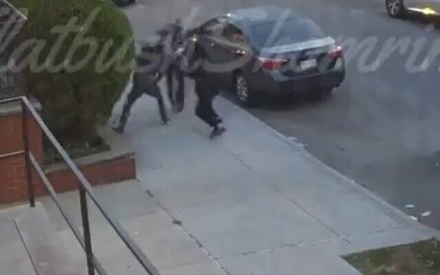 Two men assault a Jewish man on his way to synagogue, July 16, 2021 (Screen grab/Shomrim) Two men assault a Jewish man on his way to synagogue, July 16, 2021 (Screen grab/Shomrim)