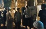 Far-right Orthodox Jewish activists install a partition to segregate men and women at the Western Wall egalitarian prayer plaza in Jerusalem during a Tisha B'Av prayer service on July 17, 2021 (Screen capture/Twitter)