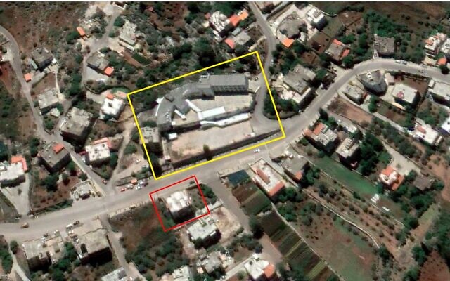 An alleged Hezbollah weapons depot (outlined in red) is seen across the street from a school (outlined in yellow) in the central Lebanese town of Ebba in a satellite image from June 1, 2020. (Google Earth, outlines added by The Times of Israel) An alleged Hezbollah weapons depot (outlined in red) is seen across the street from a school (outlined in yellow) in the central Lebanese town of Ebba in a satellite image from June 1, 2020. (Google Earth, outlines added by The Times of Israel)