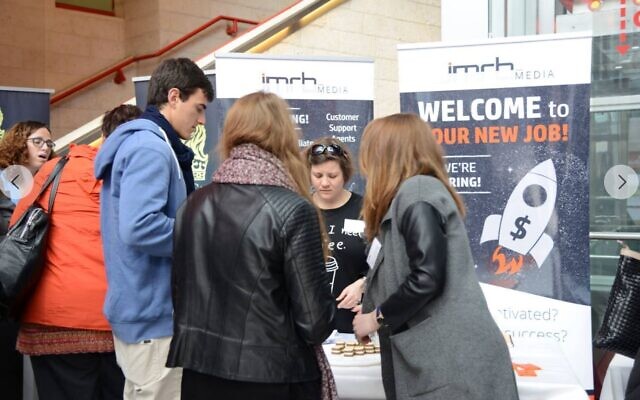 Employees of JMRB Media recruit new employees at an "Israel Multilingual Job Fair" in Tel Aviv, January 29, 2016 (Facebook screenshot) Employees of JMRB Media recruit new employees at an "Israel Multilingual Job Fair" in Tel Aviv, January 29, 2016 (Facebook screenshot)