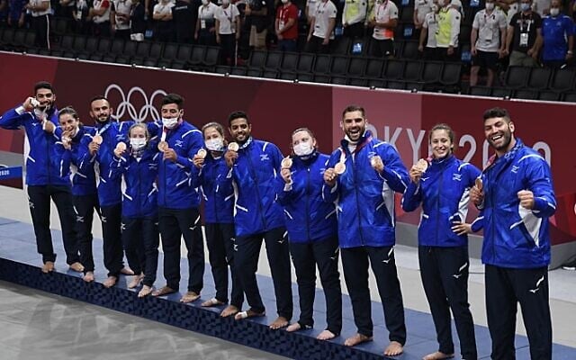 Members of Israel's team pose with their bronze medals after the medal ceremony in team judo competition at the 2020 Summer Olympics, on July 31, 2021, in Tokyo, Japan. (Israel Olympic Association) Members of Israel's team pose with their bronze medals after the medal ceremony in team judo competition at the 2020 Summer Olympics, on July 31, 2021, in Tokyo, Japan. (Israel Olympic Association)