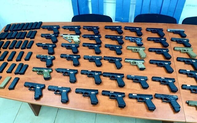 Dozens of guns seized during a smuggling operation from Lebanon, on July 10, 2021. (Israel Defense Forces) Dozens of guns seized during a smuggling operation from Lebanon, on July 10, 2021. (Israel Defense Forces)