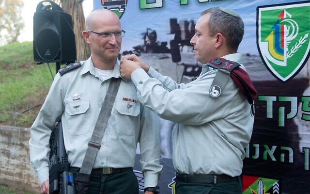 Colonel Sharon Asman, left, upon his appointment to commander of the Nahal Brigade on June 28, 2021, three days before his sudden death. (IDF)