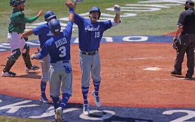 Israel's Daniel Valencia (2nd R, #19) celebrates his three run home run with teammates during the third inning of the Tokyo 2020 Olympic Games baseball round 1 game between Israel and Mexico at Yokohama Baseball Stadium in Yokohama, Japan, on August 1, 2021. (KAZUHIRO FUJIHARA / AFP)