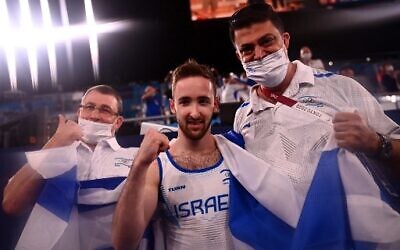 Israel's Artem Dolgopyat (C) celebrates with his team after winning the floor event of the artistic gymnastics men's floor exercise final during the Tokyo 2020 Olympic Games at the Ariake Gymnastics Centre in Tokyo on August 1, 2021. (Loic VENANCE / AFP)