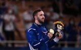 Gold medallist Israel's Artem Dolgopyat celebrates on the podium of the floor event of the artistic gymnastics men's floor exercise final during the Tokyo 2020 Olympic Games at the Ariake Gymnastics Centre in Tokyo on August 1, 2021. (Lionel BONAVENTURE / AFP)