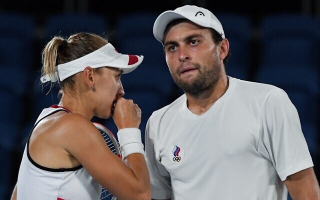 Russia's Elena Vesnina (L) talks to Russia's Aslan Karatsev during the Tokyo 2020 Olympic mixed doubles tennis final match at the Ariake Tennis Park in Tokyo on August 1, 2021. (Tiziana Fabi/AFP) Russia's Elena Vesnina (L) talks to Russia's Aslan Karatsev during the Tokyo 2020 Olympic mixed doubles tennis final match at the Ariake Tennis Park in Tokyo on August 1, 2021. (Tiziana Fabi/AFP)