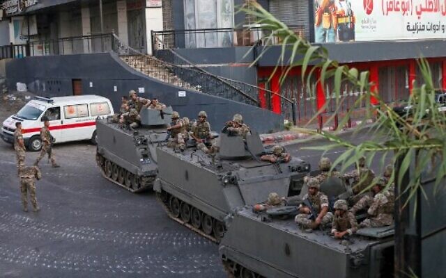Lebanese soldiers deploy in armored vehicles amid clashes in the Khalde area, south of the capital, on August 1, 2021. (Photo by ANWAR AMRO / AFP)