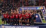 Lille's players celebrate with the trophy after winning the French Champions' Trophy (Trophee des Champions) final football match between Paris Saint-Germain (PSG) and Lille (LOSC) at the Bloomfield Stadium in Tel Aviv, Israel, on August 1, 2021. (Photo by EMMANUEL DUNAND / AFP)