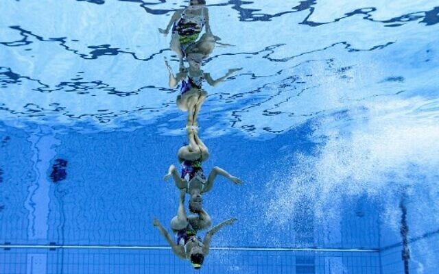 An underwater view shows Israel's Eden Blecher and Shelly Bobritsky compete in the preliminary for the women's duet free artistic swimming event during the Tokyo 2020 Olympic Games at the Tokyo Aquatics Centre in Tokyo on August 2, 2021. (François-Xavier MARIT / AFP)