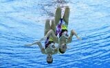 An underwater view shows Israel's Eden Blecher and Shelly Bobritsky compete in the preliminary for the women's duet free artistic swimming event during the Tokyo 2020 Olympic Games at the Tokyo Aquatics Centre in Tokyo on August 2, 2021. (François-Xavier MARIT / AFP)