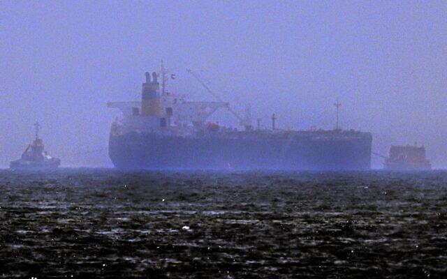 Tug boats are moored next to the Israeli-managed tanker MT Mercer Street, off the Fujayrah port in the United Arab Emirates, on August 3, 2021. (Karim Sahib/AFP)