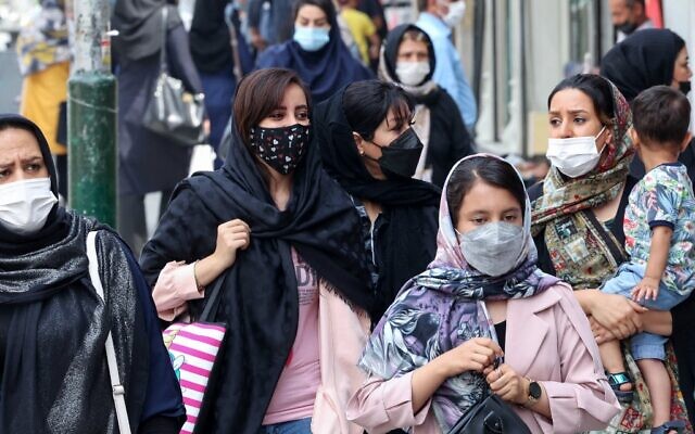 Mask-clad Iranians shop at the Tajrish Bazaar market in the capital Tehran, on August, 3 2021. (Atta Kenare/AFP)