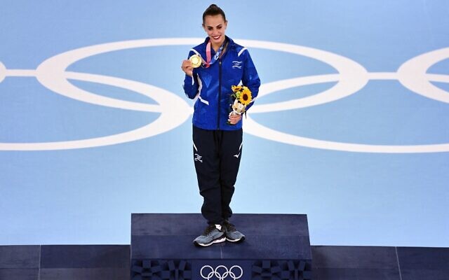 Israel's Linoy Ashram poses with her gold medal during the podium ceremony of the individual all-around final of the Rhythmic Gymnastics event during Tokyo 2020 Olympic Games at Ariake Gymnastics centre in Tokyo, on August 7, 2021. (Martin Bureau/AFP)