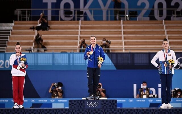 (LtoR) Russia's Dina Averina (silver), Israel's Linoy Ashram (gold) and Belarus' Alina Harnasko (bronze) pose during the medal ceremony of the individual all-around final of the Rhythmic Gymnastics event during Tokyo 2020 Olympic Games at Ariake Gymnastics centre in Tokyo, on August 7, 2021. (Lionel BONAVENTURE / AFP) (LtoR) Russia's Dina Averina (silver), Israel's Linoy Ashram (gold) and Belarus' Alina Harnasko (bronze) pose during the medal ceremony of the individual all-around final of the Rhythmic Gymnastics event during Tokyo 2020 Olympic Games at Ariake Gymnastics centre in Tokyo, on August 7, 2021. (Lionel BONAVENTURE / AFP)