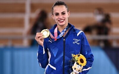 Israel's Linoy Ashram poses with her gold medal during the podium ceremony of the individual all-around final of the Rhythmic Gymnastics event during Tokyo 2020 Olympic Games at Ariake Gymnastics center in Tokyo, on August 7, 2021. (Lionel BONAVENTURE / AFP)