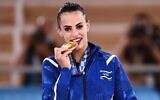 Israel's Linoy Ashram poses with her gold medal during the podium ceremony of the individual all-around final of the rhythmic gymnastics event, during Tokyo 2020 Olympic Games at Ariake Gymnastics center in Tokyo, on August 7, 2021. (Lionel Bonaventure/AFP)