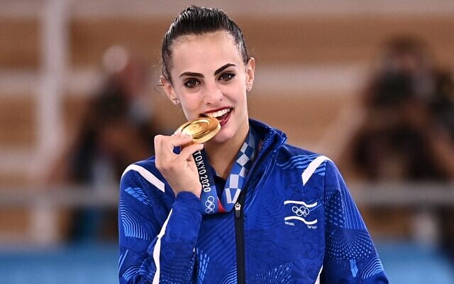 Israel's Linoy Ashram poses with her gold medal during the podium ceremony of the individual all-around final of the rhythmic gymnastics event, during Tokyo 2020 Olympic Games at Ariake Gymnastics center in Tokyo, on August 7, 2021. (Lionel Bonaventure/AFP) Israel's Linoy Ashram poses with her gold medal during the podium ceremony of the individual all-around final of the rhythmic gymnastics event, during Tokyo 2020 Olympic Games at Ariake Gymnastics center in Tokyo, on August 7, 2021. (Lionel Bonaventure/AFP)