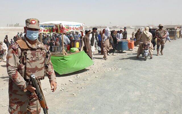 An army soldier patrols as stranded people wait for the reopening of the border crossing point which was closed by the authorities, in Chaman on August 7, 2021, after the Taliban took control of the Afghan border town in a rapid offensive across the country. (Asghar Achakzai/AFP) An army soldier patrols as stranded people wait for the reopening of the border crossing point which was closed by the authorities, in Chaman on August 7, 2021, after the Taliban took control of the Afghan border town in a rapid offensive across the country. (Asghar Achakzai/AFP)