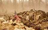 An American flag is placed on a burned fire engine at a burned fire station in downtown Greenville, California on August 7, 2021. (JOSH EDELSON / AFP)