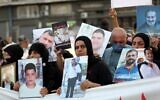 Families of the August 4 victims joined by protestors march with imitation coffins and portraits of their loved ones during a symbolic funeral procession from Beirut port on August 8, 2021, days after the first anniversary of a vast dockside explosion that left more than 200 people dead. (ANWAR AMRO / AFP)