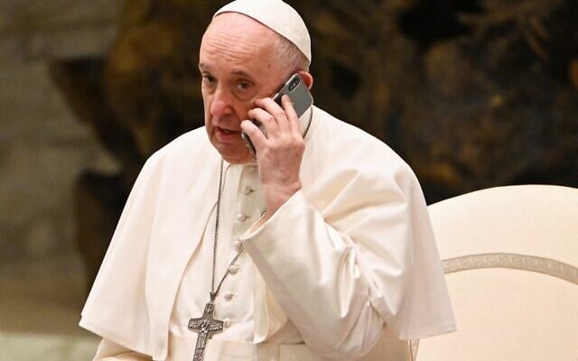 Pope Francis speaks on the phone during his weekly general audience on August 11, 2021 at Paul VI hall in the Vatican. (Photo by Andreas SOLARO / AFP) Pope Francis speaks on the phone during his weekly general audience on August 11, 2021 at Paul VI hall in the Vatican. (Photo by Andreas SOLARO / AFP)