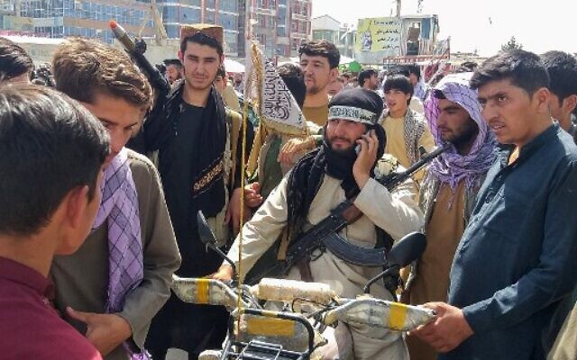 Taliban fighter (C) is seen surrounded by locals at Pul-e-Khumri on August 11, 2021 after Taliban captured Pul-e-Khumri, the capital of Baghlan province about 200 kms north of Kabul. (AFP) Taliban fighter (C) is seen surrounded by locals at Pul-e-Khumri on August 11, 2021 after Taliban captured Pul-e-Khumri, the capital of Baghlan province about 200 kms north of Kabul. (AFP)