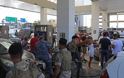 Lebanese soldiers are seen at a gas station in the capital Beirut, on August 14, 2021, after soldiers were deployed to force several stations to reopen their doors. (Anwar Amro/AFP)