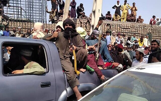 Taliban fighters sit on a vehicle along the street in Jalalabad province on August 15, 2021. (AFP)