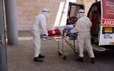 Medics with Magen David Adom transfer a coronavirus patient to the Hadassah Ein Kerem Hospital in Jerusalem, due to full capacity in other hospitals, following a sharp increase in the number of coronavirus infections in Israel, on August 15, 2021. (Menahem KAHANA / AFP)