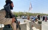 Taliban fighters stand guard at an entrance gate outside the Interior Ministry in Kabul, on August 17, 2021. (Javed Tanveer/AFP)