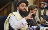 Taliban spokesperson Zabihullah Mujahid (L) gestures as he speaks during the first press conference in Kabul on August 17, 2021, following the Taliban's stunning takeover of Afghanistan. (Hoshang Hashimi / AFP)